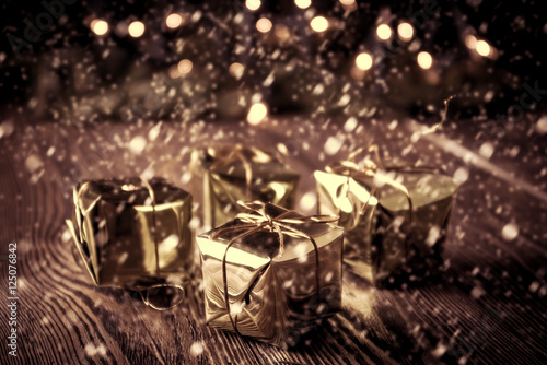 New year, christmas vintage background. Christmas gifts box on wooden table. Retro toned.