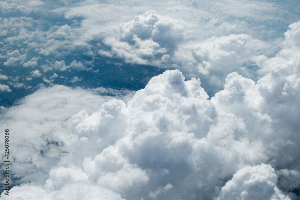 Clouds and sky as seen through window of an aircraft Clouds and sky as seen through window of an aircraft