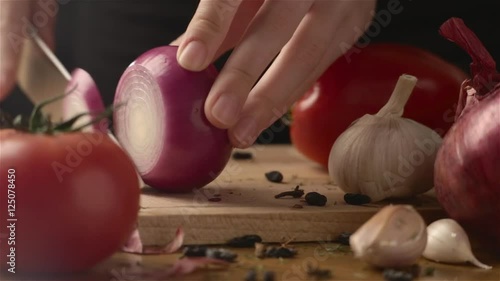 Female hands cutting onion whith knife