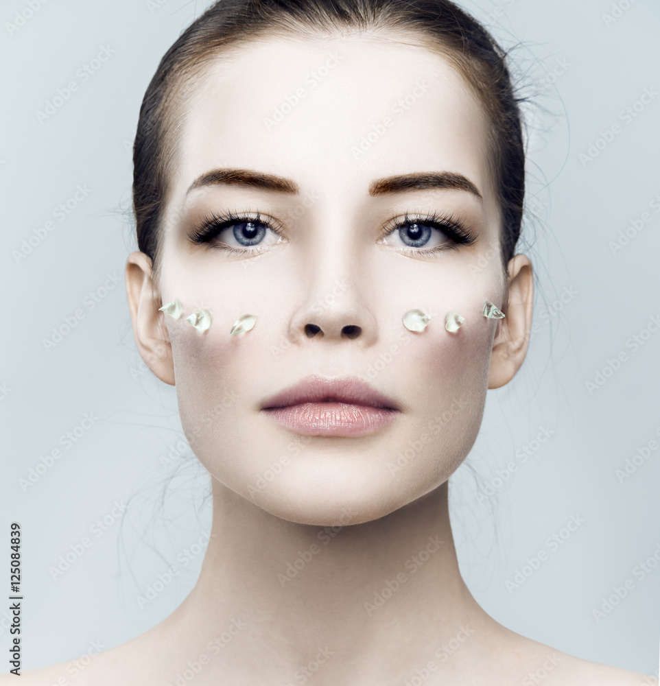 Fashion beautiful woman with drops of gel on another cheek Fashion beautiful woman with drops of gel on another cheek