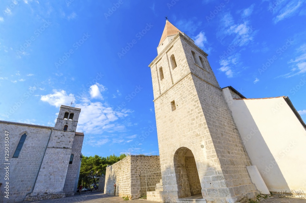 Pyramidal tower of the Church of our Lady of Health, a romanesque cathedral formely named St Michael the archangel, basilica at the Square of the Glagolitic housed monasteries on Krk island, Croatia.