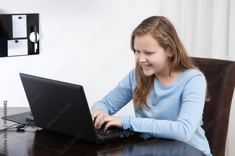 young pretty girl texting on the laptop young pretty girl texting on the laptop