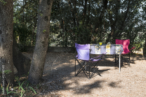 Table and chairs on campsite