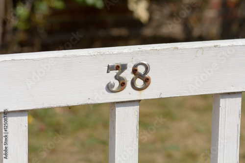 House Number 38 sign on gate