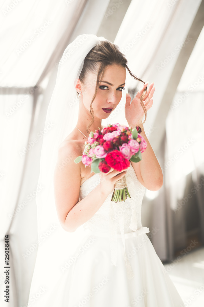 Luxury wedding bride, girl posing and smiling with bouquet Luxury wedding bride, girl posing and smiling with bouquet
