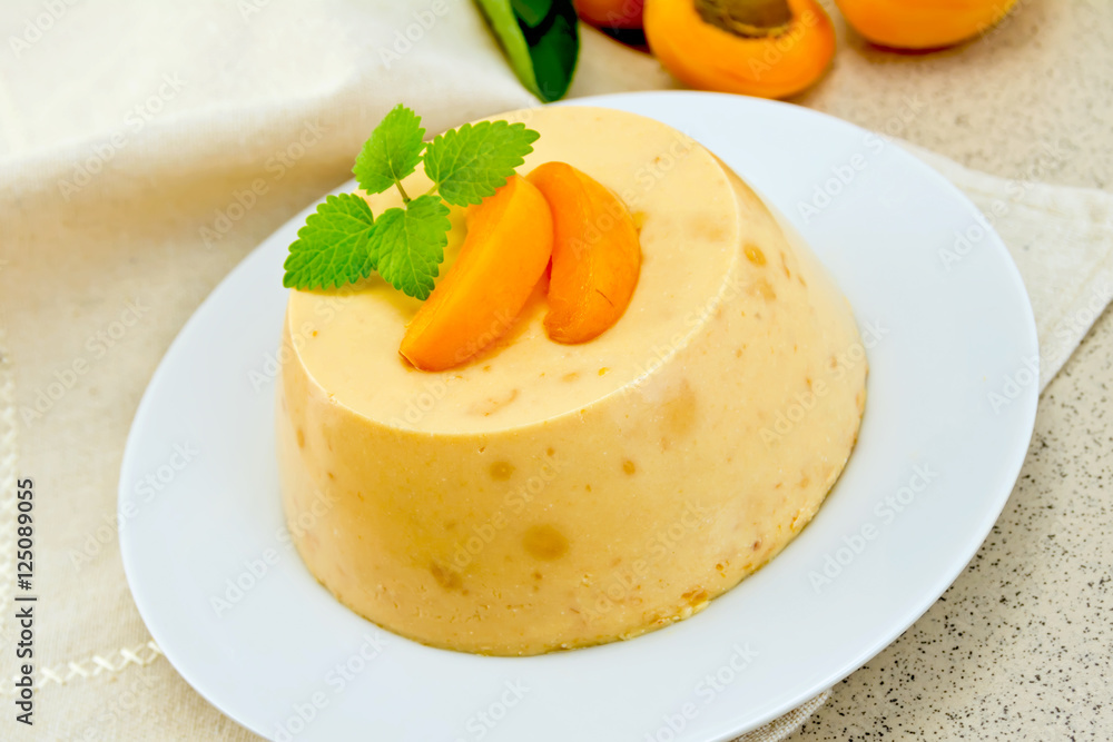 Panna cotta apricot with mint on napkin Panna cotta apricot with mint on napkin