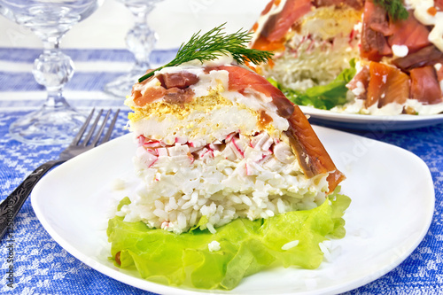 Salad with salmon and rice in plate on tablecloth