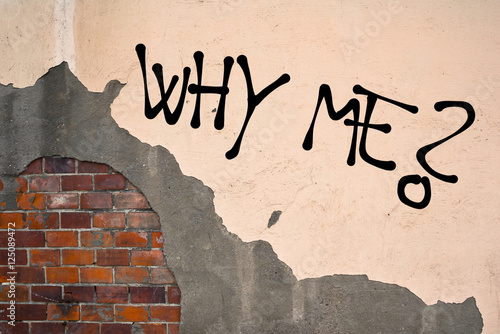 Why Me? - handwritten graffiti sprayed on the wall - innocent sufferer and victim is asking on unfair misery and tragedy photo