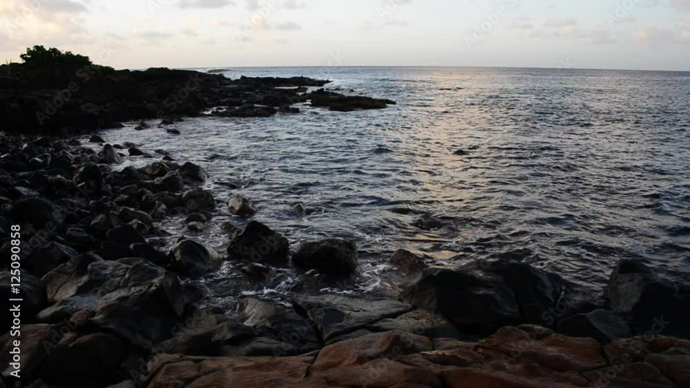 Scenic seascape in Hawaii, waves crash on rocks.