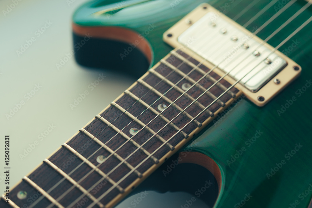 Fototapeta premium Electric guitar body and neck detail on wooden background