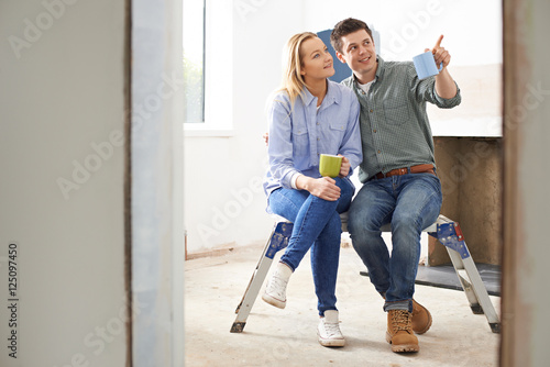 Couple Sitting In Property Being Rennovated photo