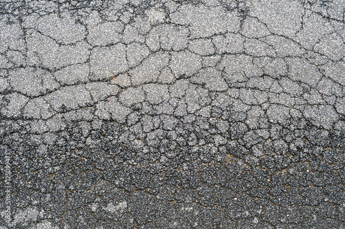 Urban road with damaged asphalt, from above