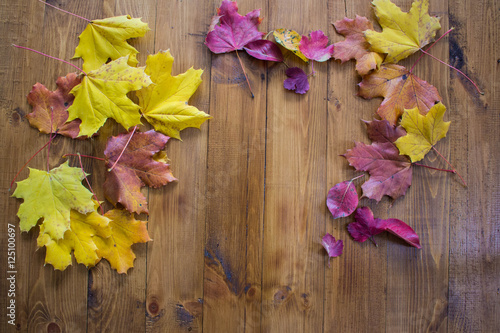 Autumn leaves on wooden floor