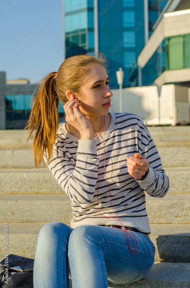 Fototapeta premium Young woman listening to music