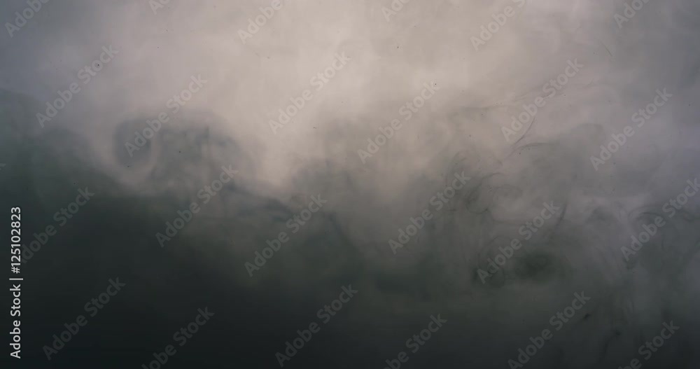 gray ink cloud floating in milky water gray ink cloud floating in milky water