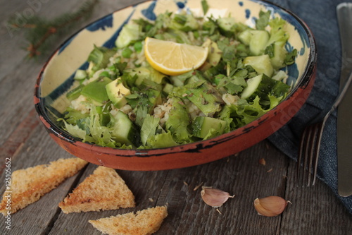 vegan healthy salad with bulgur, cucumber, avocado and crispy toast