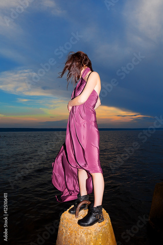 woman in long purple dress background sunset