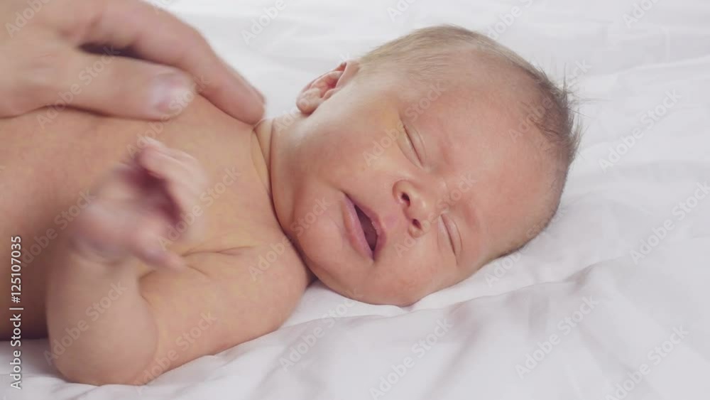 Father play with newborn with a rattle toy.
Father play with newborn with a rattle toy.