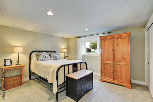 Beige tone bedroom interior with iron bed