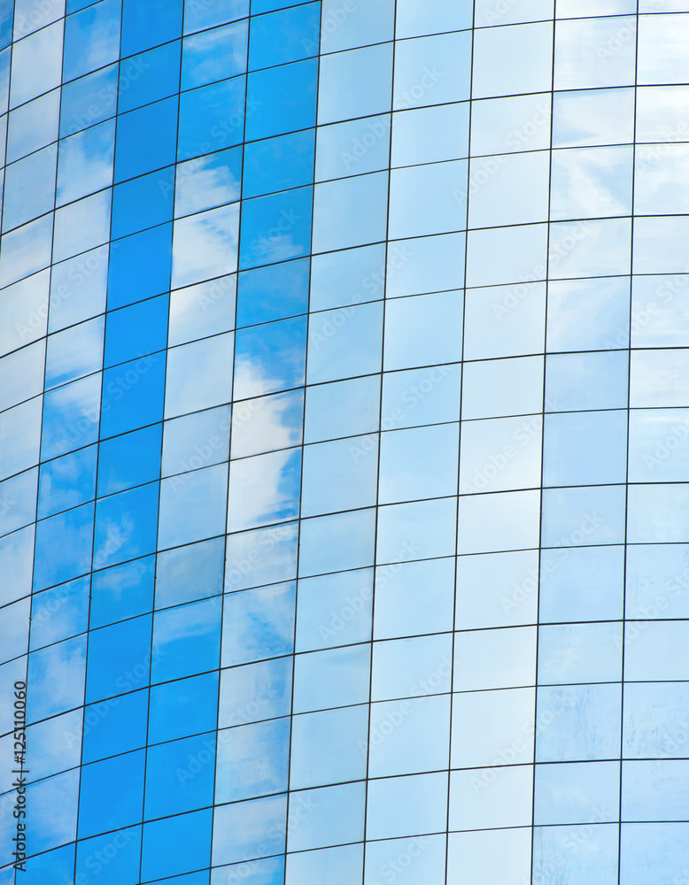 Modern glass skycrapers background with sky and clouds reflecti Modern glass skycrapers background with sky and clouds reflecti