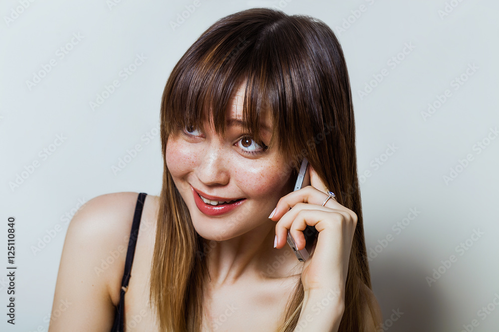 Pretty girl portrait talking on the phone and smiling Pretty girl portrait talking on the phone and smiling