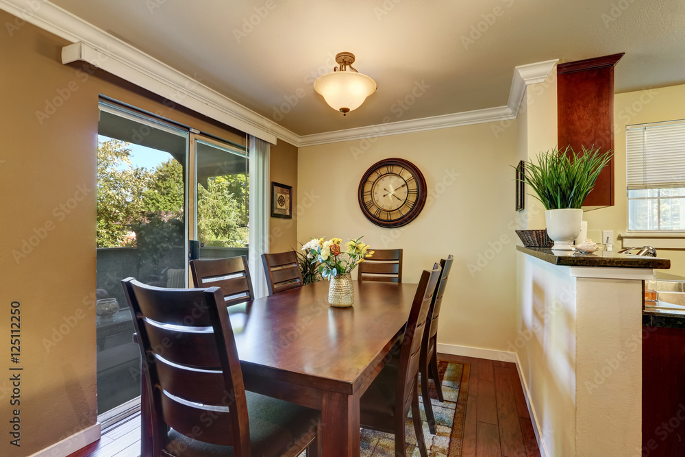 Dining area with nice wooden table set and fresh flowers. Dining area with nice wooden table set and fresh flowers.