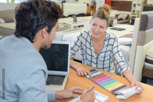 Woman in soft furnishings store choosing color scheme