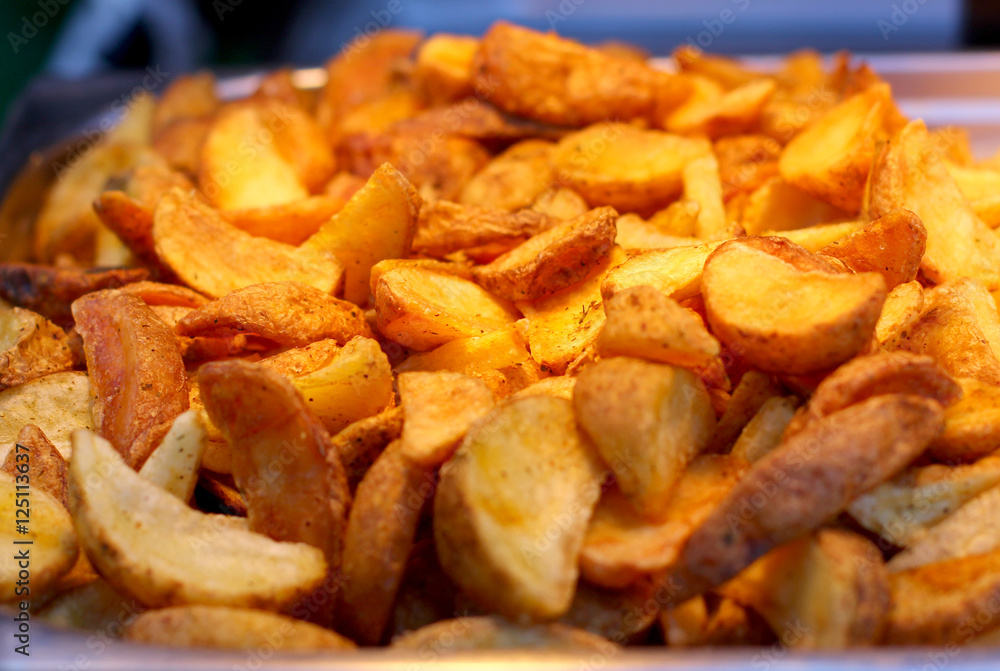 Large pan of natural food cooked sweet potato fries, fresh out of frying oil yellow colorful close up patterns Large pan of natural food cooked sweet potato fries, fresh out of frying oil yellow colorful close up patterns