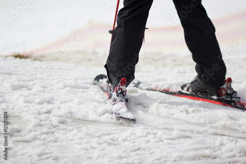 legs of skier on a loose snow hills photo