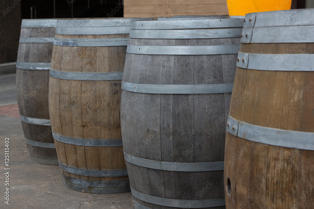 four wooden wine barrels kegs in a row
