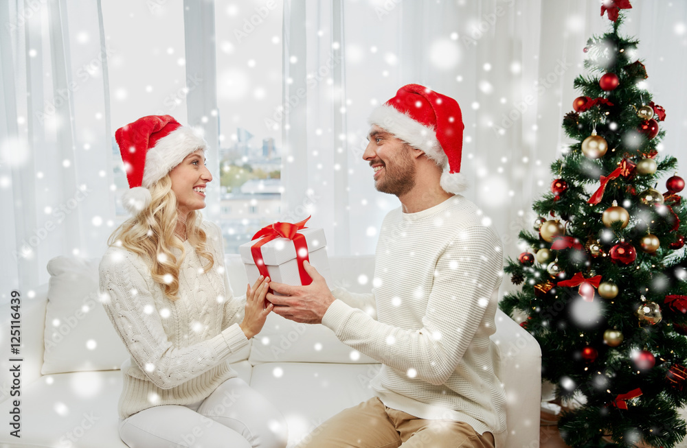 happy couple at home with christmas gift box happy couple at home with christmas gift box