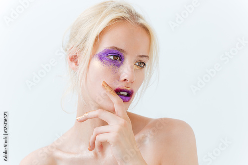 Beauty portrait of pretty girl with stylish purple makeup