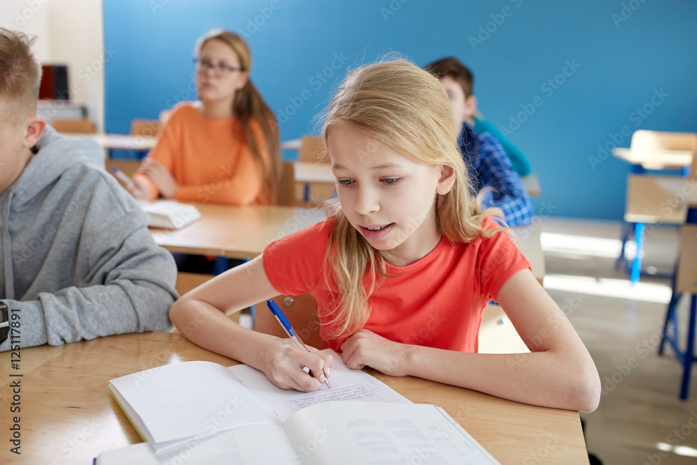 Fototapeta premium student girl with book writing school test