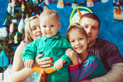 Warm hugs of loving parents and their children before a Christma