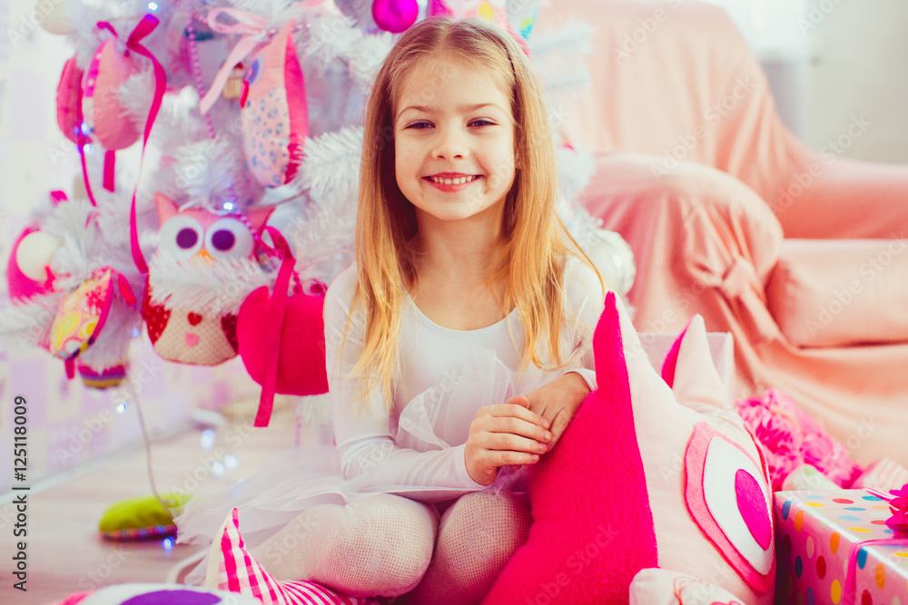 Blonde girl smiles broad while sitting on the pink toy owl befor Blonde girl smiles broad while sitting on the pink toy owl befor