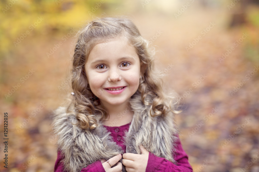 Adorable little girl in a autumn forest Adorable little girl in a autumn forest