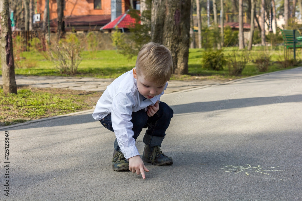 Blond boy is drawing the picture Blond boy is drawing the picture