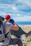 Backpacker man hiking and taking pictures of Barranco del Infierno in Tenerife. Canary islands, Spain