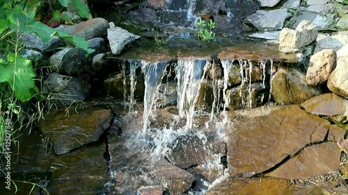 Cinemagraphic view of the waterfall. Photography in motion cinemagraph. Nature is soothing and relaxing. Lively picture of the water flow.  photo