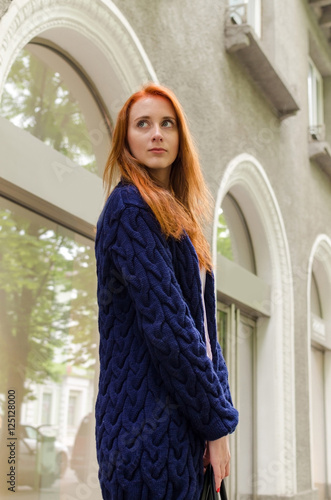 Young red woman walking in the city