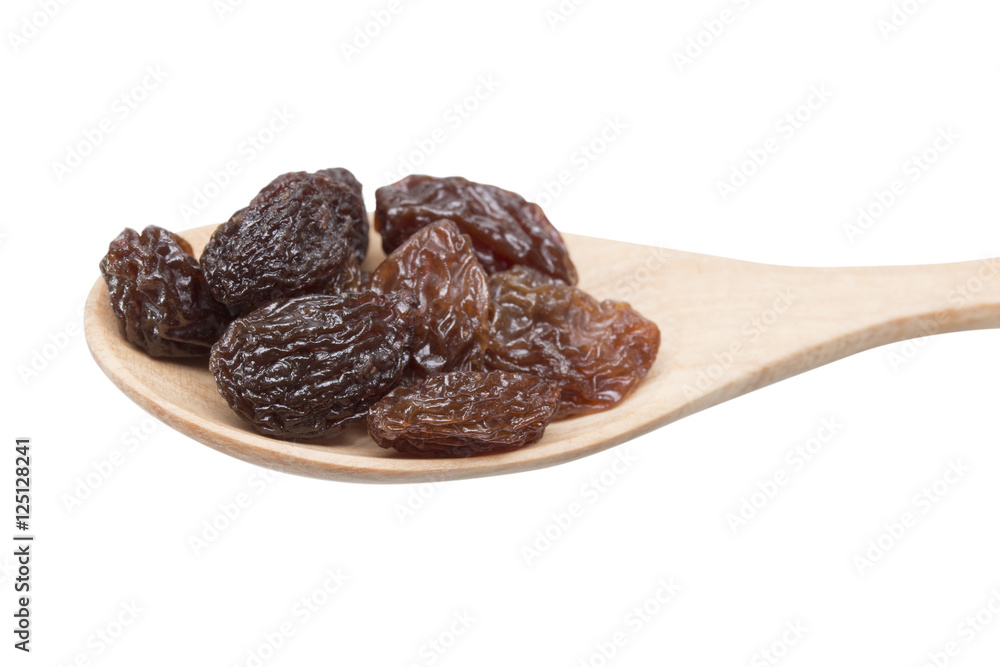 raisins in spoon on white background. raisins in spoon on white background.