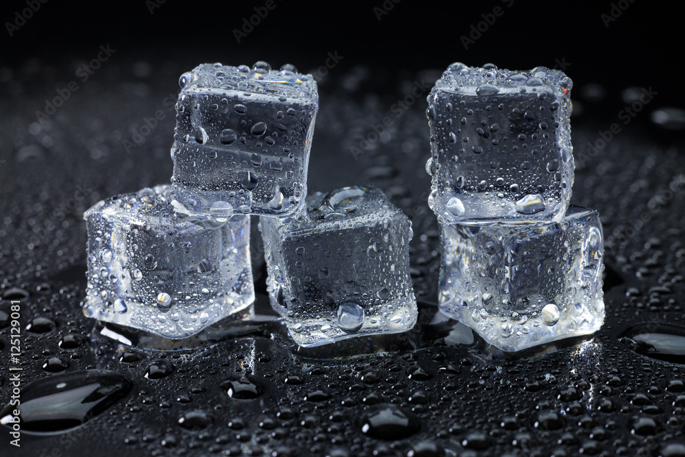 Wet ice cubes and water drop on black background. Wet ice cubes and water drop on black background.