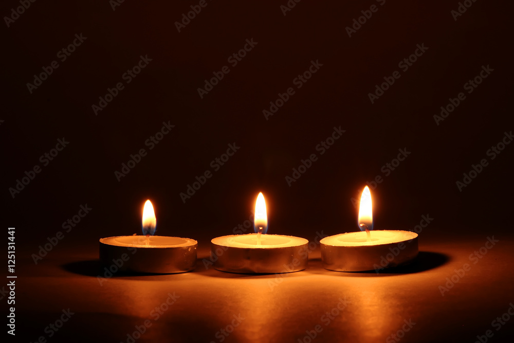 Burning candles on dark background Burning candles on dark background