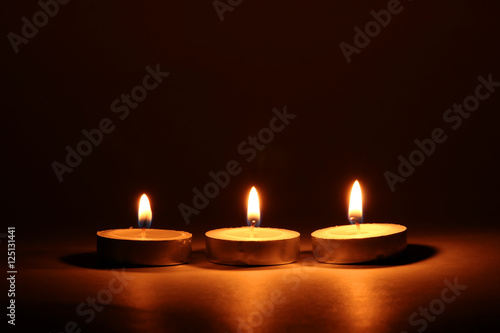 Burning candles on dark background