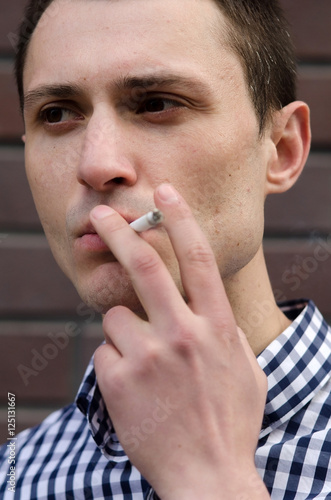 Young man smoking cigarette 