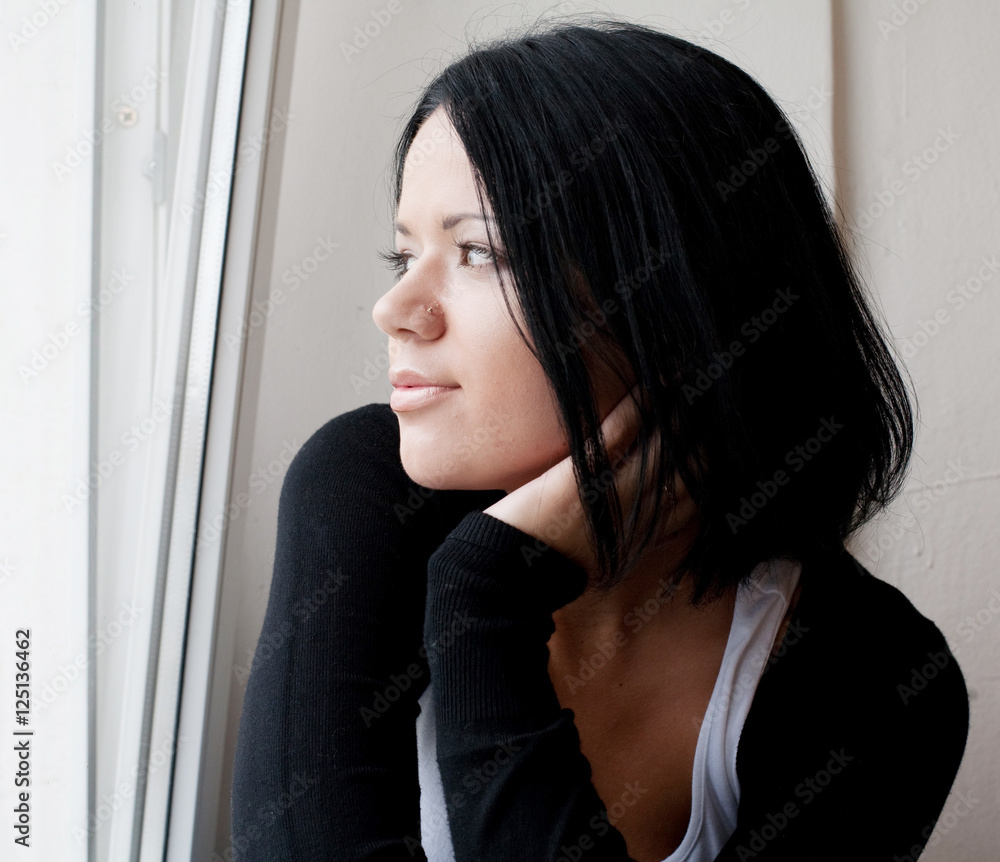 woman looking through a window. woman looking through a window.
