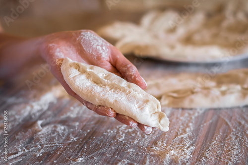 patty of raw dough in a female hand