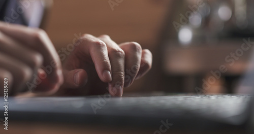 young man working on notebook in cafe or home hands closeup