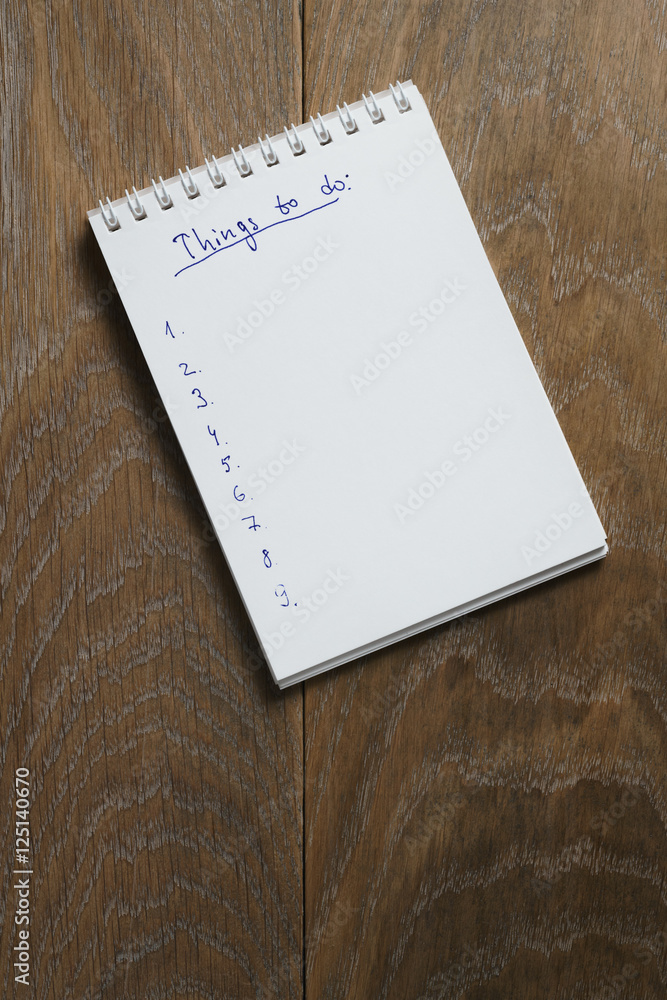 things to do list on notepad on wood table things to do list on notepad on wood table