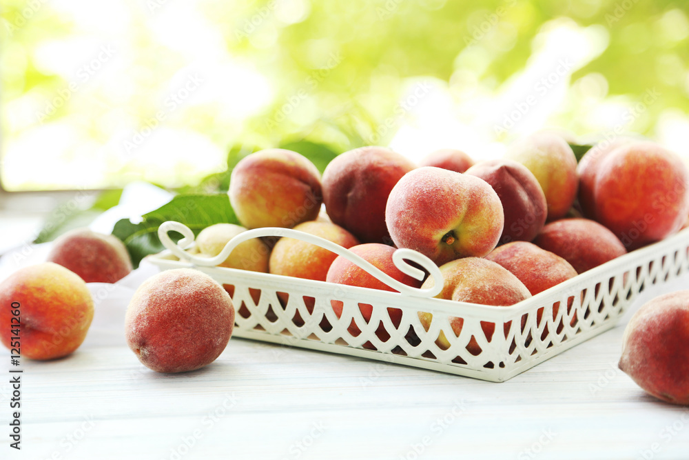 Sweet peach fruit in tray on white wooden table Sweet peach fruit in tray on white wooden table